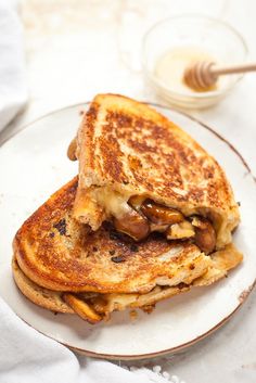 a grilled cheese and mushroom sandwich on a plate next to a glass of milk