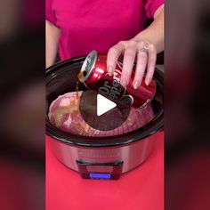 a woman is pouring coke into an slow cooker to make meat in the crock pot