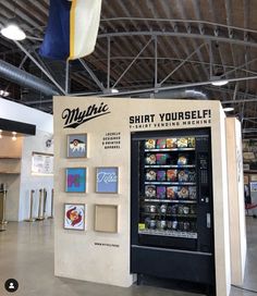 a vending machine in the middle of a building with an american flag hanging from it's ceiling