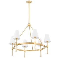 a brass chandelier with white shades