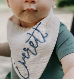 a close up of a baby wearing a bib