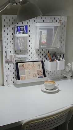 a cup of coffee sitting on top of a white desk