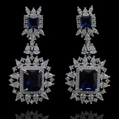 For edgy style and sophisticated sparkle, this pair is a dream come true! Elegant and shimmering pair with CZ and sapphire stones creating a flawlessly fresh finish for each and every one of your evening ensembles. Approximate earrings length is 2.1". Designed over a high-quality brass as base metal. Available in 3 plating options. Made by order. Kindly allow 4-6 weeks for the delivery of this item. For custom or urgent requests, please contact support@alacouture.com. *Please Note: We use faux s Elegant Hand-set Crystal Earrings, Dazzling Drop Earrings, Glamorous Hand Set Drop Earrings, Diamond Hand-set Earrings For Party, Hand Set Diamond Drop Earrings For Party, Hand Set Crystal Dangle Earrings, Hand-set Crystal Dangle Earrings, Hand Set Diamond Earrings For Party, Party Hand Set Cubic Zirconia Chandelier Earrings