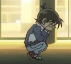 an animated image of a boy sitting on the ground with his hands in his pockets