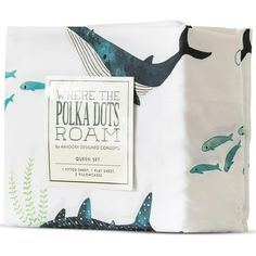 a sheet set with blue and white whale prints on the sheets, along with a tag that says where the polka dots roam