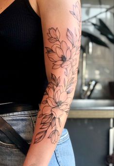 a woman with a flower tattoo on her arm