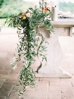 an olive branch tied to a table with flowers