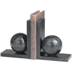 two bookends with black marble balls on them