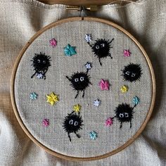 an embroidery project with black and white animals on it