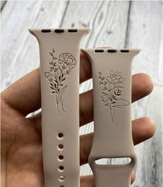 two white watch bands with flowers on them