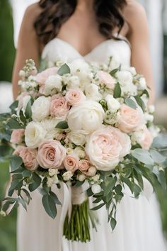 a bridal holding a bouquet of pink and white flowers