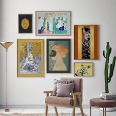 a living room filled with lots of art on the wall above a chair and table