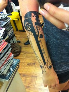 a woman with a clock tattoo on her arm