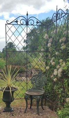 a bench and table in the middle of a garden