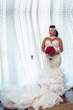 a woman in a wedding dress holding a bouquet