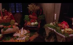 several baskets filled with vegetables sitting on top of a table next to candles and other items