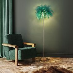 a green chair sitting next to a tall lamp