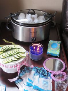 a table topped with plates and bowls filled with food next to a slow cooker