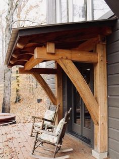 a wooden porch with rocking chairs on it