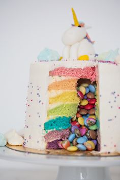 there is a cake that has been decorated with rainbows and candies on it