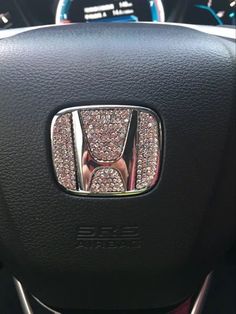 the interior of a car with an image of a honda badge on it's center console