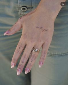 a woman's hand with tattoos on it and her name written in cursive writing