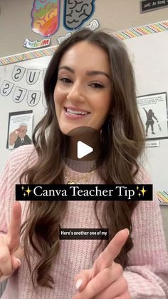 a woman giving the thumbs up sign in front of a classroom wall with pictures on it