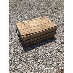 a wooden box sitting on top of gravel