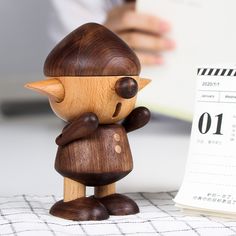 a wooden figurine next to a calendar