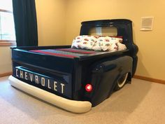 a bed made to look like an old chevrolet truck