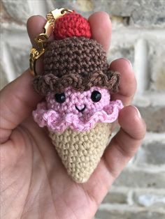 a small crocheted ice cream cone keychain with a cherry on top