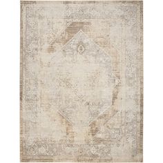 an antique style rug in beige and brown tones with a medallion design on the center