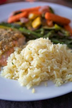 a plate with rice, meat and vegetables on it