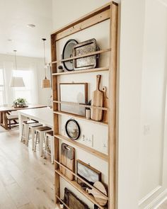 a kitchen with white walls and wooden shelves