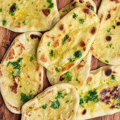 several flat breads with green herbs on them