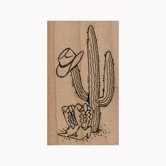 a wooden stamp with a cactus and hat on it