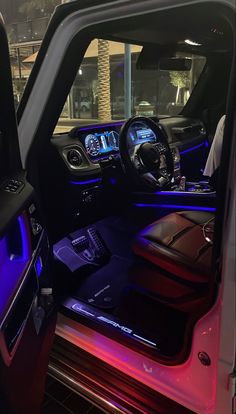 the interior of a vehicle with blue and red lights on it's dash boards