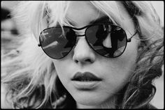 black and white photograph of a woman wearing sunglasses