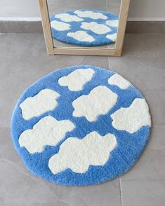 a blue and white rug sitting on top of a tile floor next to a mirror