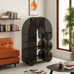 a living room filled with furniture next to a window and bookshelf in the corner