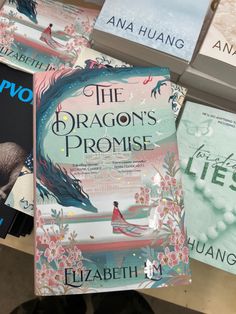 the dragon's promise by elizabeth j huang on display in a book store