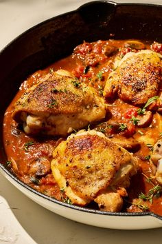 a pan filled with chicken and tomato sauce