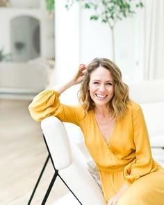 a woman sitting on top of a white couch