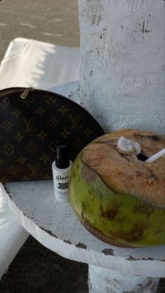 a bagel sitting on top of a white table next to a brown handbag