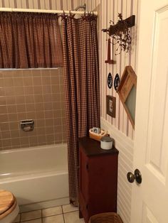 a bathroom with a sink, toilet and bathtub next to a shower curtain in it