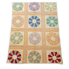 a multicolored quilt with flowers on it