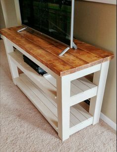 an entertainment center with a flat screen tv on top