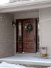 the front door of a house with snow on the ground