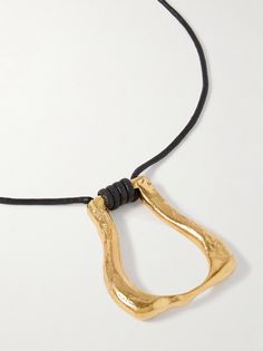 "Find ALIGHIERI The Link Of Wanderlust Recycled -plated Cord Necklace on Editorialist. Inspired by the photographs of her father's road trip to Zimbabwe in the '80s; Alighieri designer Rosh Mahtani created this 'Link of Wanderlust' necklace as a \"symbol of human connection\" and the \"unspoken bond\" she has with her dad. Crafted in London from gold-plated recycled bronze, the abstract charm is suspended from a black Japanese cord that can be adjusted using the ties at each side." Rosh Mahtani, Alighieri Jewellery, Wanderlust Necklace, Long Statement Necklace, Boho Style Jewelry, Long Necklaces, Human Connection, Jewelry Style, Zimbabwe