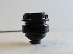 a black object sitting on top of a white floor